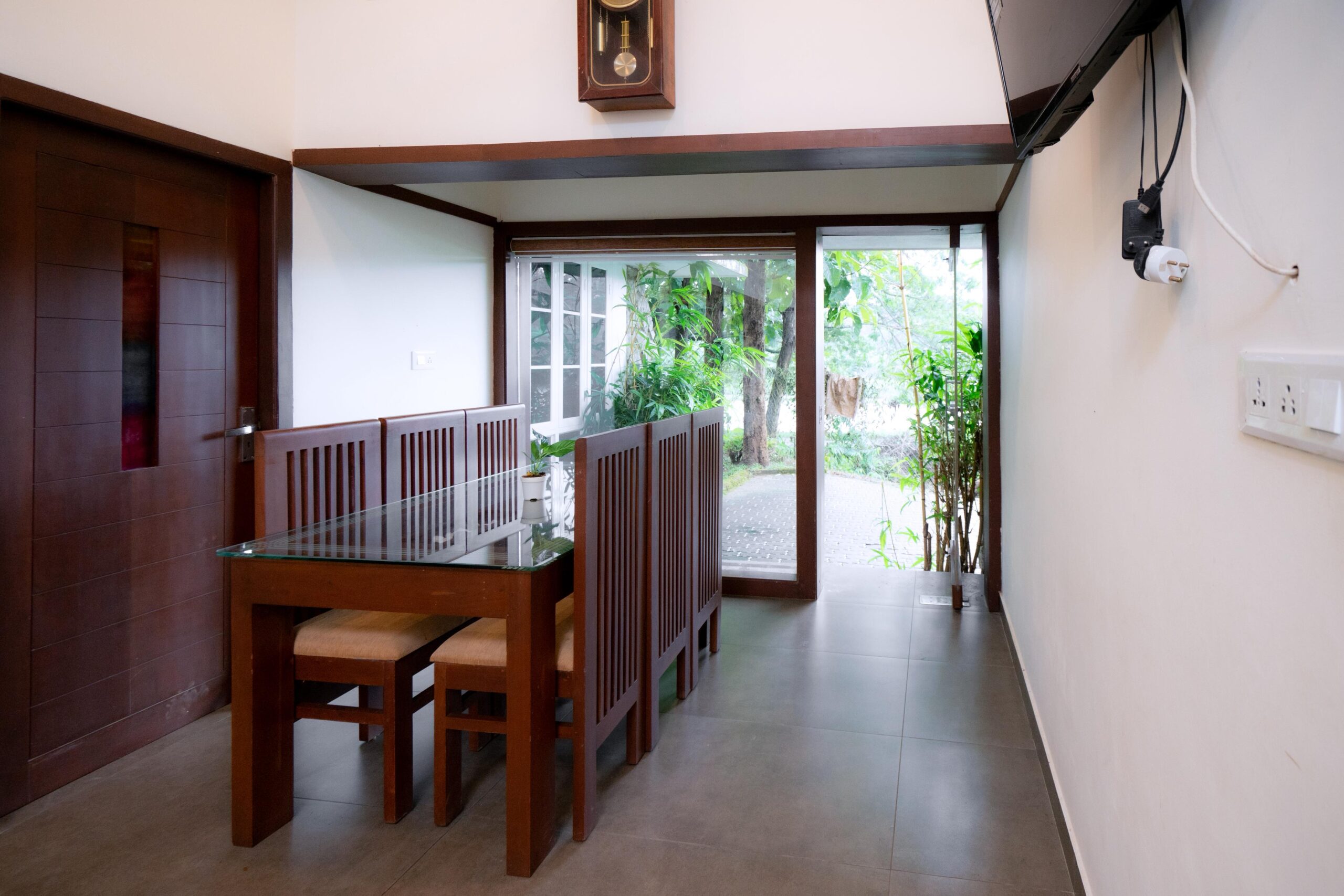 a dining area and a table and chairs in it in Best Home Stay in nilambur